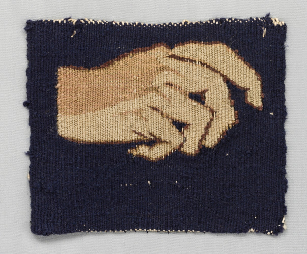 A small weaving showing a hand against a dark blue background