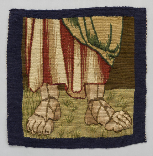 A small weaving showing two feet in sandals