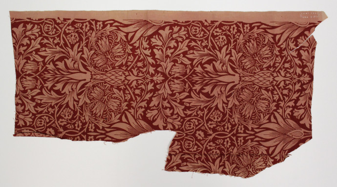 Fabric sample with a floral design in deep red.