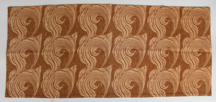 A repeating textile pattern showing swirling leaves in shades of orange